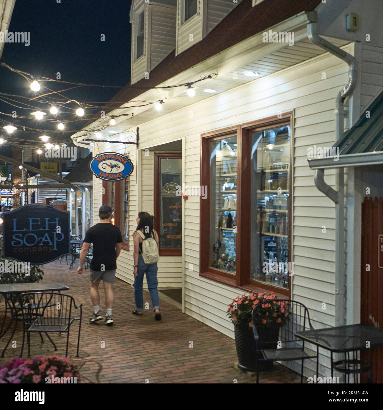 A couple strolls through one of the retail alleyways in Rehoboth Beach, Delaware's shopping district. Stock Photo