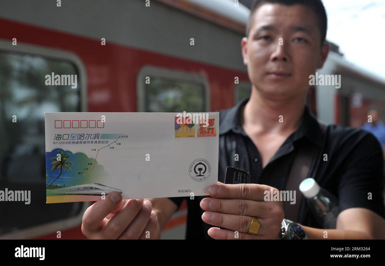 Bildnummer: 59930882  Datum: 02.07.2013  Copyright: imago/Xinhua (130702) -- HAIKOU, July 2, 2013 (Xinhua) -- A passenger shows a souvenir envelope for the first direct train from Haikou to Harbin at the Haikou Railway Station in Haikou, capital of south China s Hainan Province, July 2, 2013. The train K1122/3 from south China s Haikou to northeast China s Heilongjiang left Haikou Tuesday, a day later than its original departure date due to the tropical storm Rumbia. The train which travels 4,458 kilometers for 65 hours has connected China s southernmost capital city Haikou of Hainan Province Stock Photo