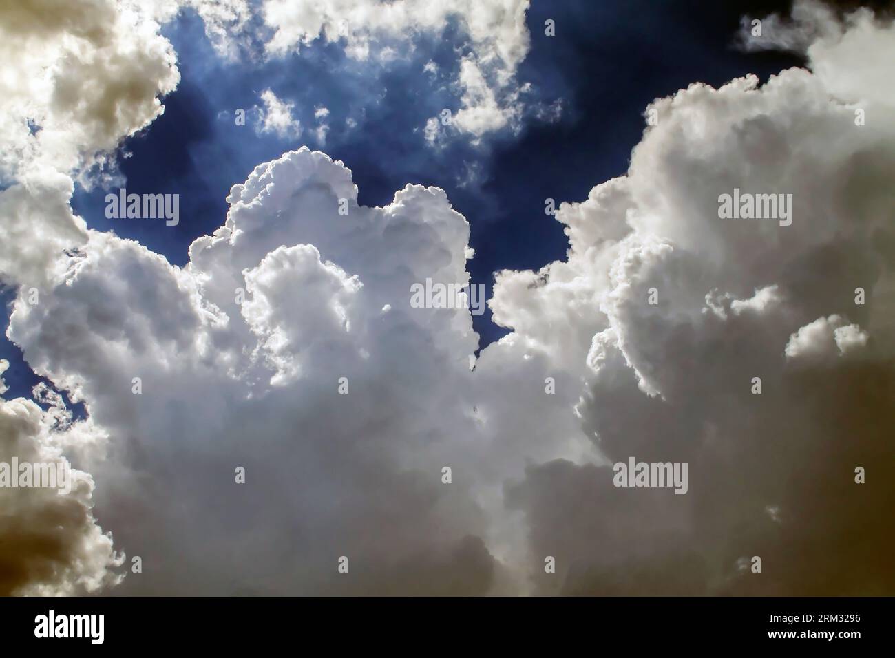 Blue summer sky with fluffy white clouds Stock Photo - Alamy