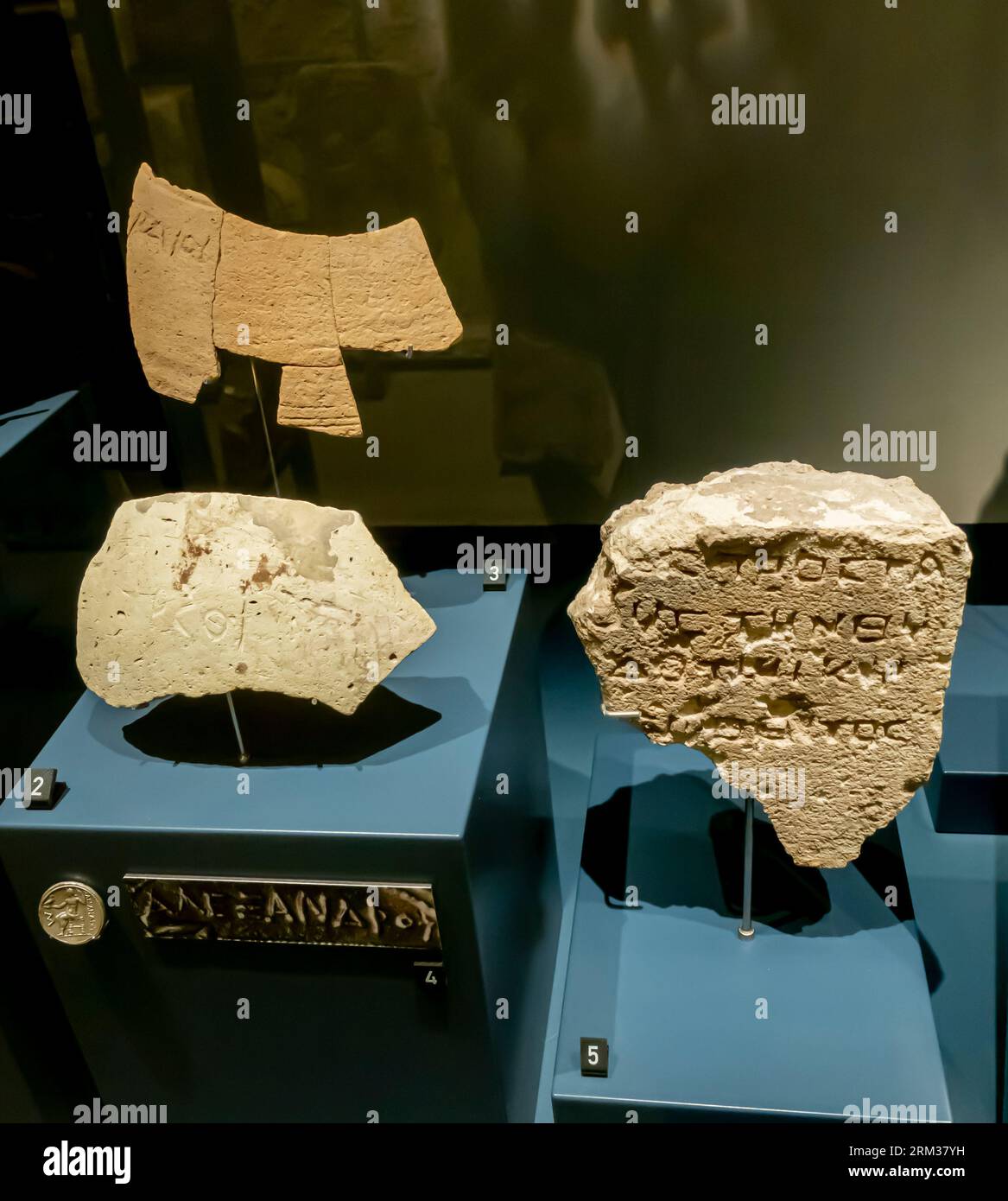 Potsherds (left) with a graffito - 1st-2nd century A.D. Stone block with Greek inscription (right) Limestone. Bahrain fort museum Stock Photo