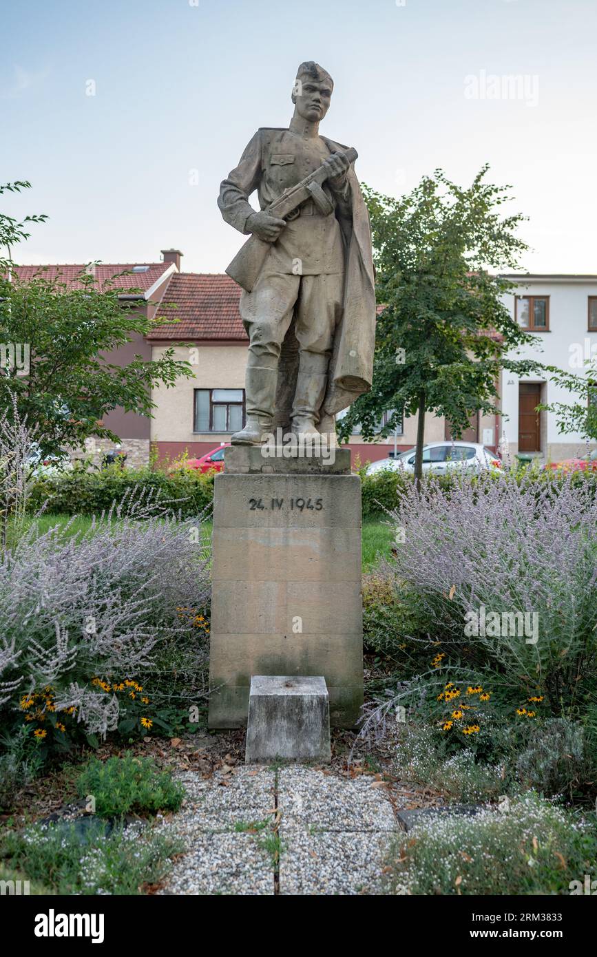 Statue of a Red Army soldier holding a submachine gun (stylized PPSh-41 with a drum magazine) from 1948 by Stanislav Hanzl in Šlapanice, Moravia. Stock Photo