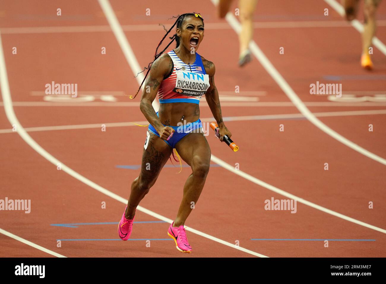 Sha'Carri Richardson, of the United States, celebrates after she crosse