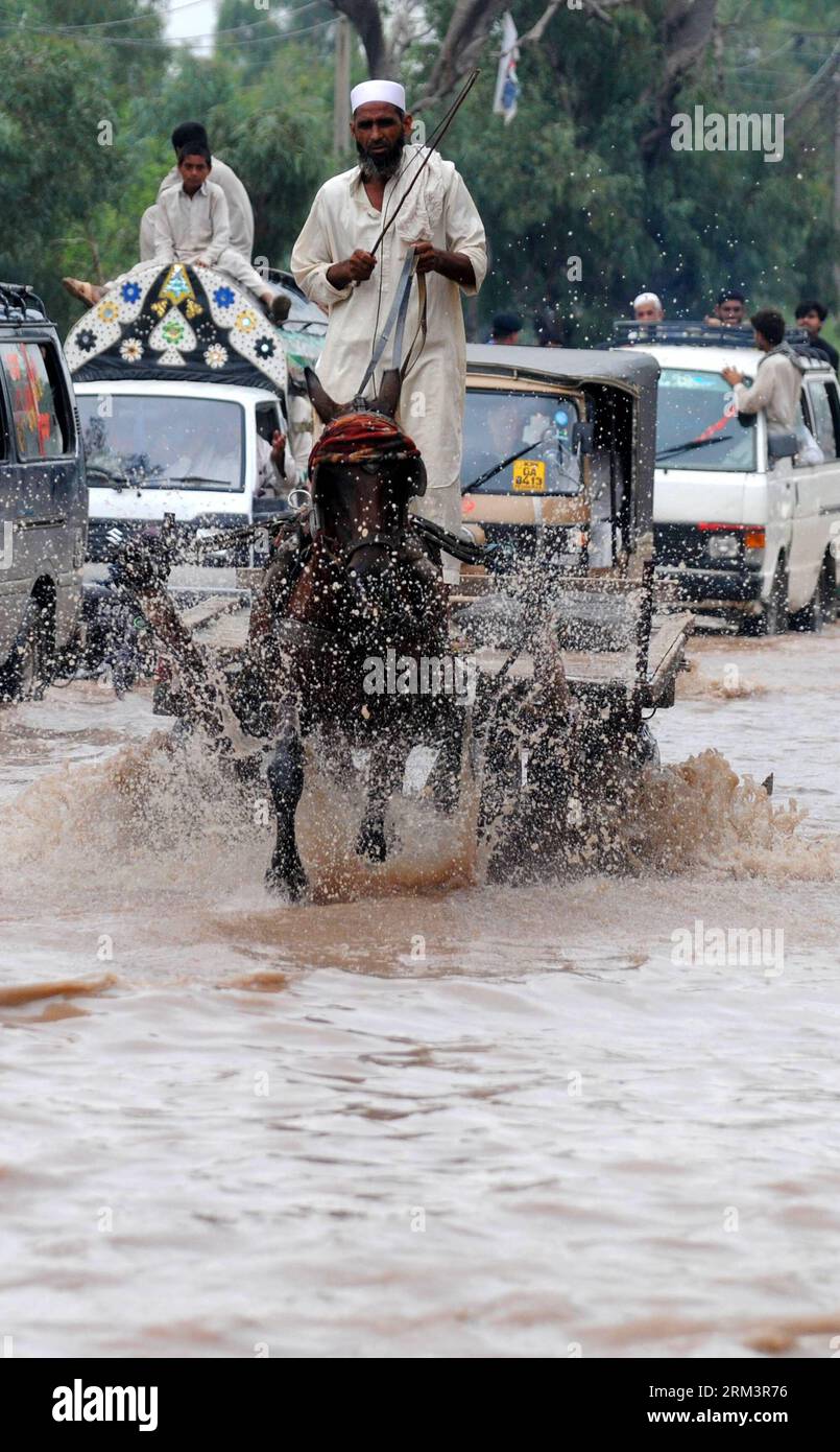 Bildnummer: 60303272  Datum: 03.08.2013  Copyright: imago/Xinhua  A man rides a donkey-cart in floodwaters after heavy rain in northwest Pakistan s Peshawar, on Aug. 3, 2013. At least seven were killed, several houses were washed away and villages inundated as floods devastated parts of Pakistan s northwestern province of Khyber Pakhtunkhwa, including the provincial capital Peshawar, local media reported on Saturday. (Xinhua/Umar Qayyum) (syq) PAKISTAN-PESHAWAR-FLASH FLOOD PUBLICATIONxNOTxINxCHN Gesellschaft Überschwemmung Flut Wetter premiumd xsp x0x 2013 hoch     60303272 Date 03 08 2013 Cop Stock Photo