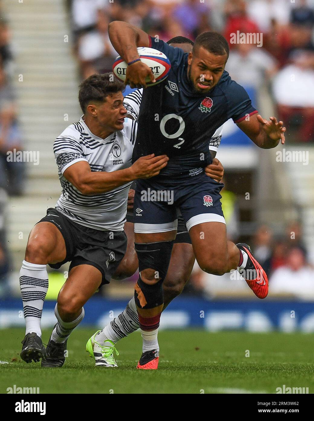 Ollie Lawrence of England tackled by Caleb Muntz of Fiji and Semi Radradra of Fiji during the