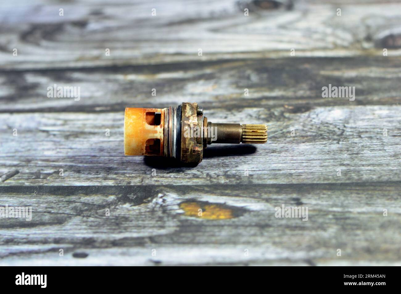 A used shower faucet tap body cartridge parts of plastic and copper