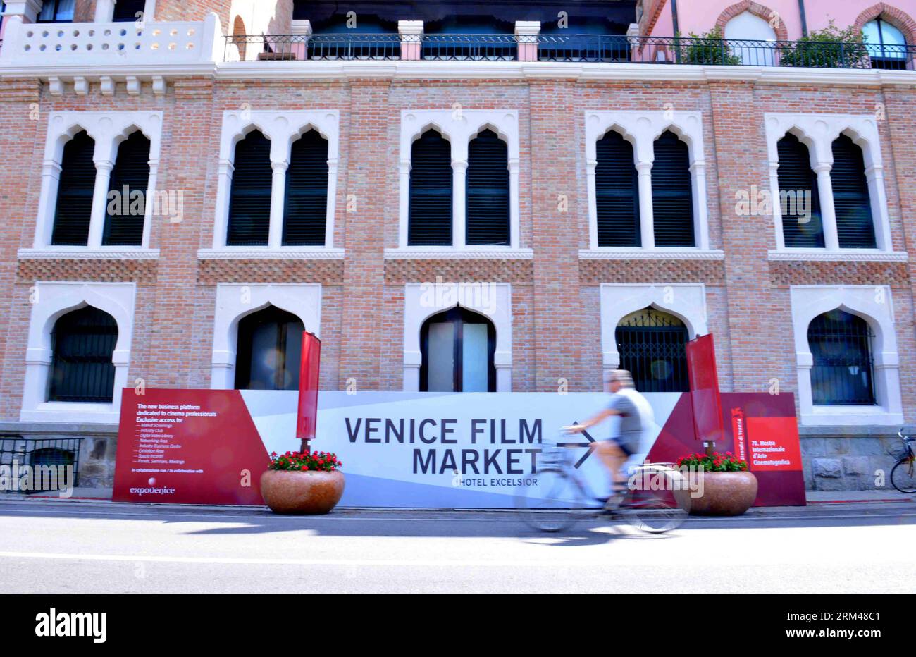 Bildnummer: 60398106  Datum: 27.08.2013  Copyright: imago/Xinhua (130827) -- VENICE, Aug. 27, 2013 (Xinhua) -- A resident on bicycle passes by a display board near the venue of the Venice International Film Festival, in Venice, Italy, Aug. 27, 2013. The 70th edition of the Venice International Film Festival is expected to start on Aug. 28 on the Lido island of Venice. (Xinhua/Xu Nizhi) (srb) ITALY-VENICE-FILM FESTIVAL PUBLICATIONxNOTxINxCHN Kultur Entertainment Film 70 Internationale Filmfestspiele Venedig Vorschau xas x0x 2013 quer premiumd      60398106 Date 27 08 2013 Copyright Imago XINHUA Stock Photo