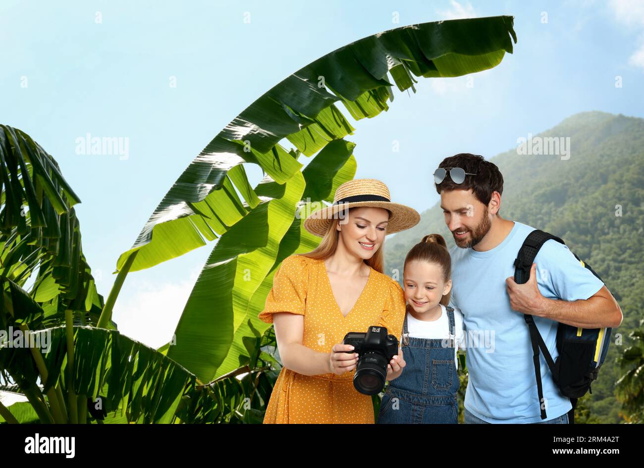 Family with child in mountains. Mother showing photo on camera Stock ...