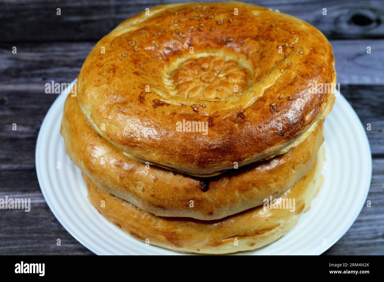 Tandyr nan Uzbek bread, a type of Central Asian bread, often decorated by stamping patterns on the dough by using a bread stamp known as a chekich, al Stock Photo