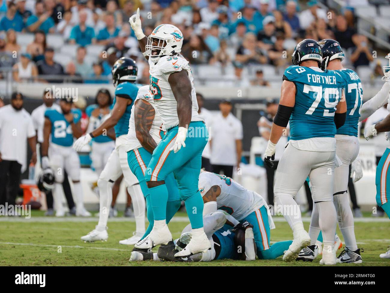 Miami Dolphins defensive tackle Josiah Bronson (95) reacts after taking