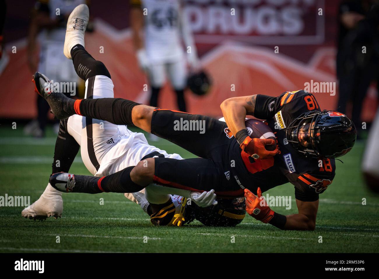 BC Lions' Justin McInnis (18) is tackled by Hamilton Tiger-Cats