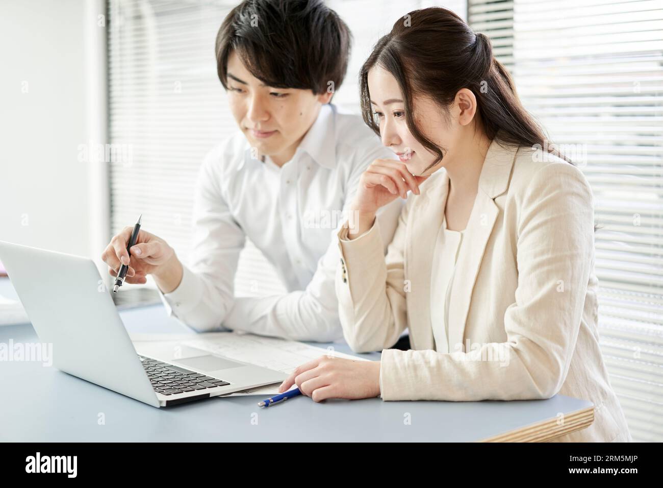 Asian architect having a meeting by looking at a computer Stock Photo