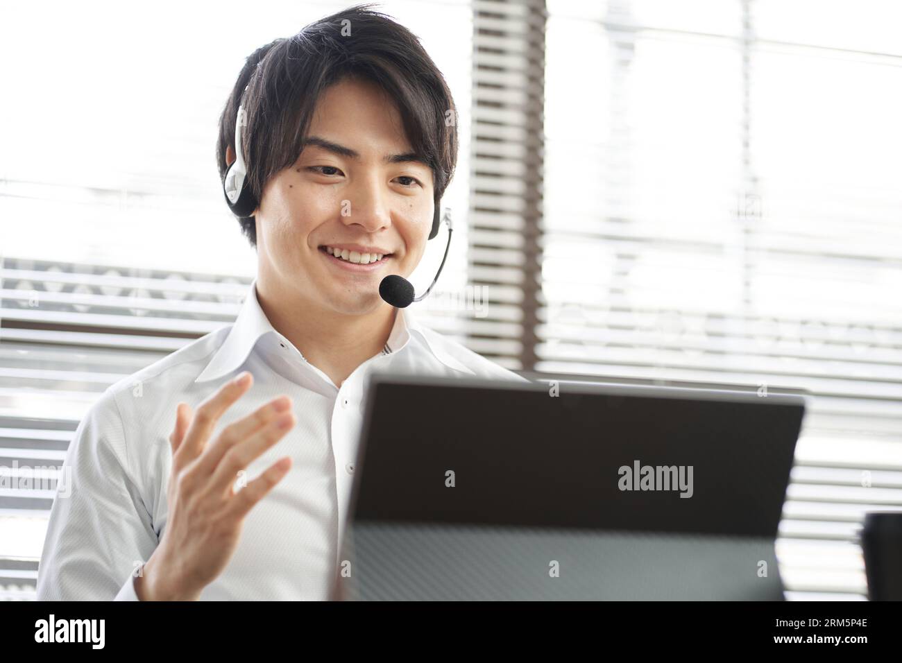 Asian businessman having an online meeting on a computer Stock Photo