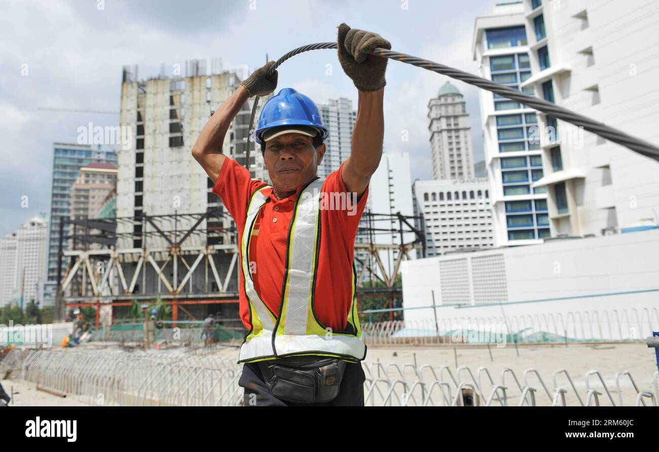 Bildnummer: 60753393  Datum: 25.11.2013  Copyright: imago/Xinhua     (131125) -- JAKARTA, Nov. 25, 2013 (Xinhua) -- A worker holds a steel wire for an overpass project as an alternative to reduce traffic in main streets in Jakarta, Indonesia, Nov. 25, 2013. (Xinhua/Agung Kuncahya B.) INDONESIA-JAKARTA-DAILY LIFE PUBLICATIONxNOTxINxCHN xcb x0x 2013 quer Stock Photo