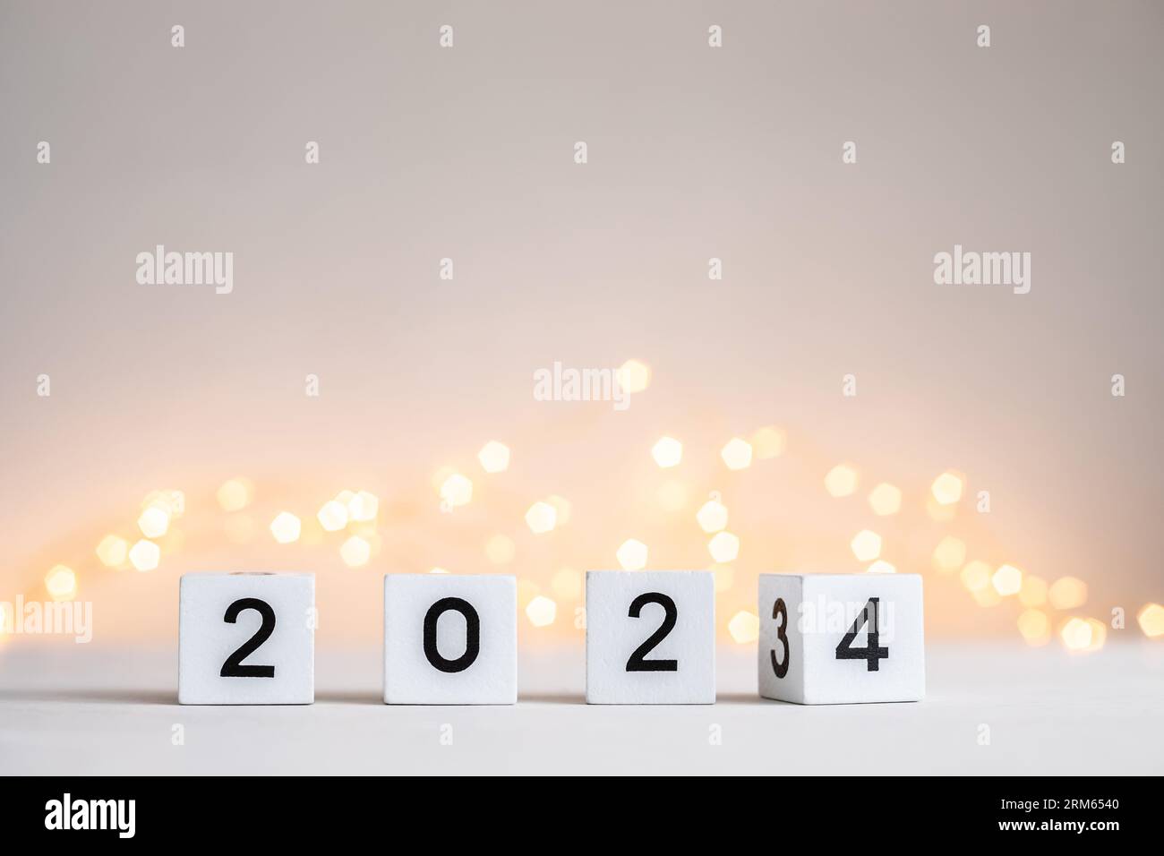 New Year 2025 coming. Numbers on wooden block cubes rotating from 2023