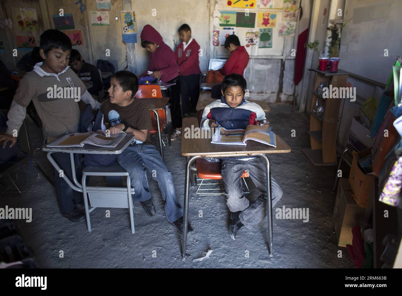 Bildnummer: 60815777  Datum: 10.12.2013  Copyright: imago/Xinhua     TIJUANA,  -- Photo shows children studying inside their classroom in the The New Hope school in Tijuana, northwest Mexico. The school New Hope , which was just opened two months ago, has 51 students from 1st until sixth grade of elementary school. It is supported by the National Educational Development Council, the only official institution that gives them didactic material and a monthly economic stimulus of 1900 pesos, for the two teachers in the school. The school was built by the students parents, with waste materials. Tha Stock Photo