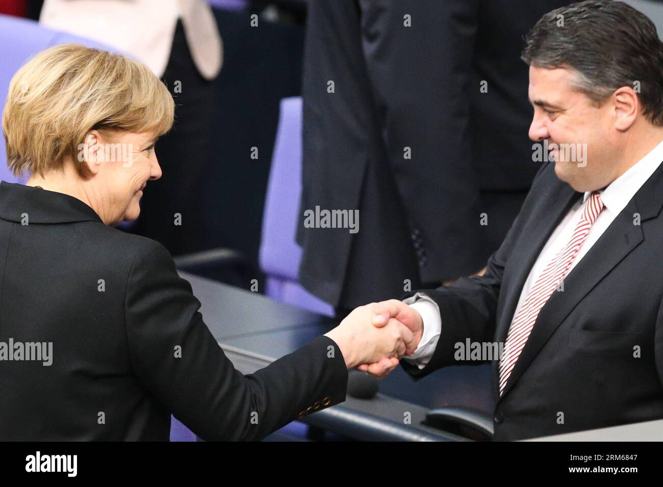 131217 -- BERLIN, Dec. 17, 2013 Xinhua -- German Chancellor Angela Merkel L shakes hands with German Vice-Chancellor and Minister of Economics and Energy Sigmar Gabriel during the meeting of Bundestag, Germany s lower house of parliament, in Berlin, Germany on Dec. 17, 2013. German new government headed by Chancellor Angela Merkel was sworn into office on Tuesday to rule Europe s biggest economy for the next four years. Cabinet ministers of the new coalition government, are formed by Merkel s Christian Democratic Union CDU, its Bavarian sister party Chrisitian Social Union CSU, and the Social Stock Photo