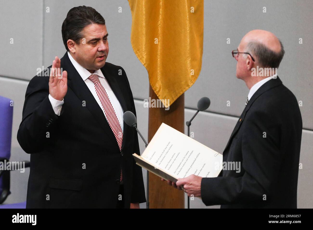 (131217) -- BERLIN, Dec. 17, 2013 (Xinhua) -- German Vice-Chancellor and Minister of Economics and Energy Sigmar Gabriel (L) is sworn-in by Parliament President Norbert Lammert during the meeting of Bundestag, Germany s lower house of parliament, in Berlin, Germany on Dec. 17, 2013. German new government headed by Chancellor Angela Merkel was sworn into office on Tuesday to rule Europe s biggest economy for the next four years. Cabinet ministers of the new coalition government, are formed by Merkel s Christian Democratic Union (CDU), its Bavarian sister party Chrisitian Social Union (CSU), and Stock Photo
