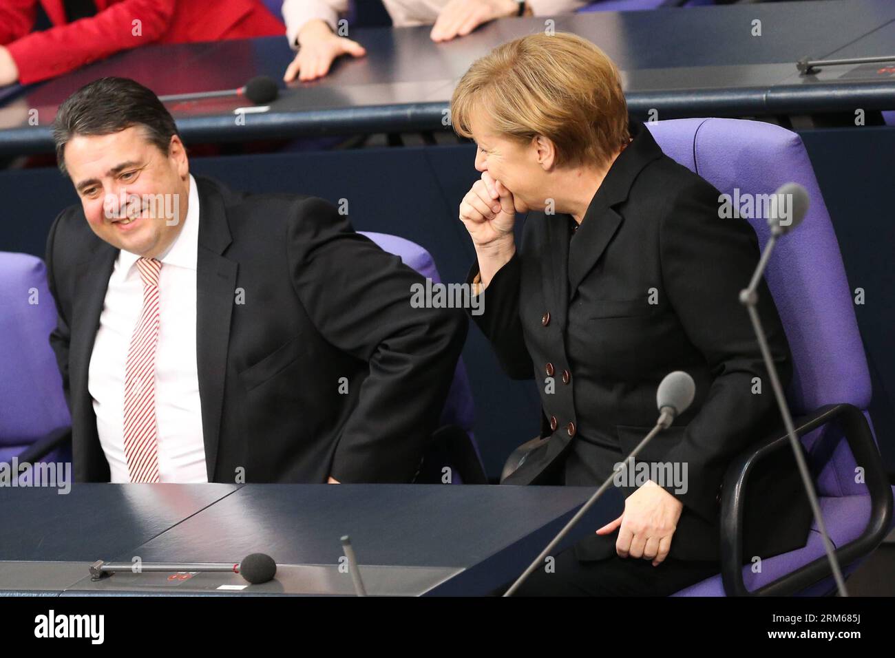 (131217) -- BERLIN, Dec. 17, 2013 (Xinhua) -- German Chancellor Angela Merkel (R) and German Vice-Chancellor and Minister of Economics and Energy Sigmar Gabriel attend the meeting of Bundestag, Germany s lower house of parliament, in Berlin, Germany on Dec. 17, 2013. German new government headed by Chancellor Angela Merkel was sworn into office on Tuesday to rule Europe s biggest economy for the next four years. Cabinet ministers of the new coalition government, are formed by Merkel s Christian Democratic Union (CDU), its Bavarian sister party Chrisitian Social Union (CSU), and the Social Demo Stock Photo