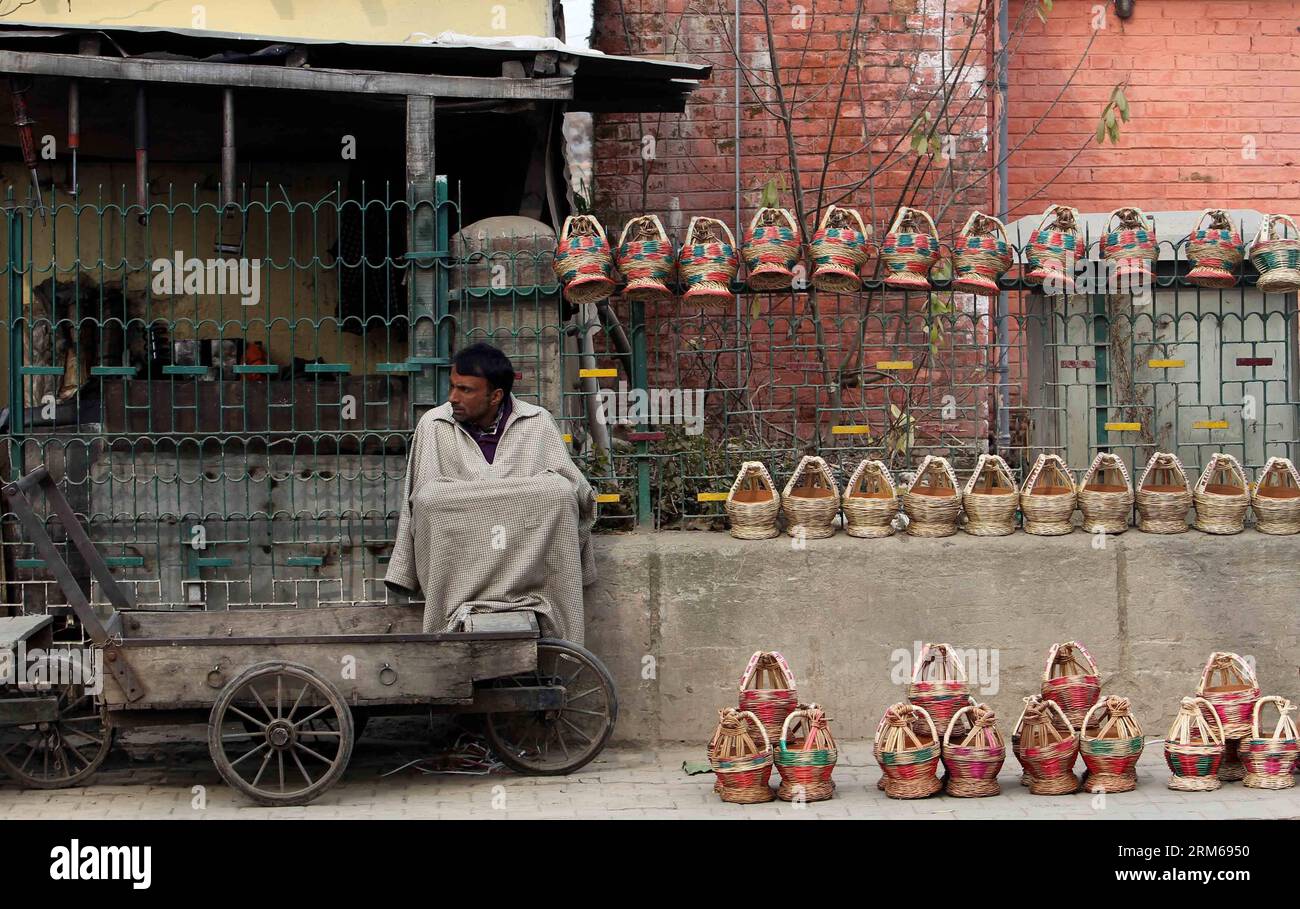 (131221) -- SRINAGAR, Dec. 21, 2013 (Xinhua) -- A Kashmiri vendor sells traditional fire-pots, or Kangris, on a cold day in Srinagar, summer capital of Indian-controlled Kashmir, Dec. 21, 2013. The 40-day harshest period of winter in Kashmir Valley, known as Chillai-Kalan , began on Saturday with a cold morning. (Xinhua/Javed Dar)(srb) KASHMIR-SRINAGAR-COLD WAVE PUBLICATIONxNOTxINxCHN   Srinagar DEC 21 2013 XINHUA a Kashmiri Vendor sells Traditional Fire Pot or  ON a Cold Day in Srinagar Summer Capital of Indian Controlled Kashmir DEC 21 2013 The 40 Day  Period of Winter in Kashmir Valley know Stock Photo