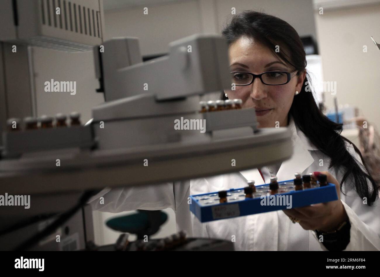 (140109) -- QUITO, Jan. 9, 2014 (Xinhua) -- A biochemist works in a laboratory of quality control, in Quito, capital of Ecuador, on Jan. 9, 2014. The Public Municipal Company of Potable Water and Sanitation of Quito (EPMAPS, for its acronym in Spanish), has implemented various quality controls to accomplish the parameters demanded by the control organizations, like training water testers in Ecuador, who can distinguish the flavors of water to offer a quality service of potable water for citizens of the Ecuadorian capital. (Xinhua/Santiago Armas) ECUADOR-QUITO-TECHNOLOGY-WATER PUBLICATIONxNOTxI Stock Photo