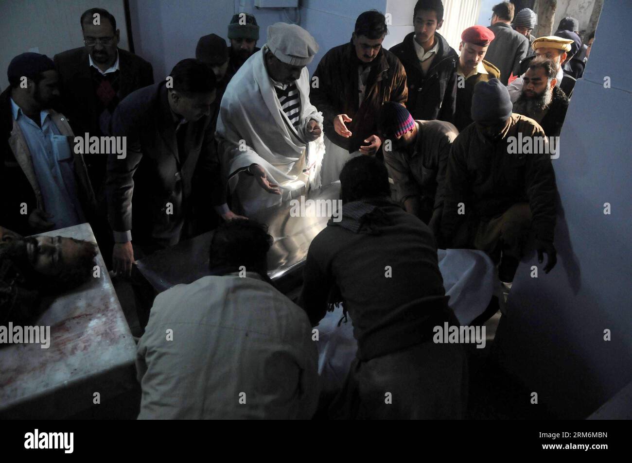(140120) -- RAWALPINDI, Jan. 20, 2014 (Xinhua) -- People transfer a body of a victim to a hospital in Rawalpindi, adjacent city of Islamabad, capital of Pakistan, Jan. 20, 2014. At least 13 people were killed and over 20 others injured when a suicide bomber blew himself up near a police check post jointly owned by police and Pakistani army in Rawalpindi on Monday morning, officials said. (Xinhua/Ahmad Kamal) PAKISTAN-RAWALPINDI-SUICIDE-ATTACK PUBLICATIONxNOTxINxCHN   Rawalpindi Jan 20 2014 XINHUA Celebrities Transfer a Body of a Victim to a Hospital in Rawalpindi adjacent City of Islamabad Cap Stock Photo