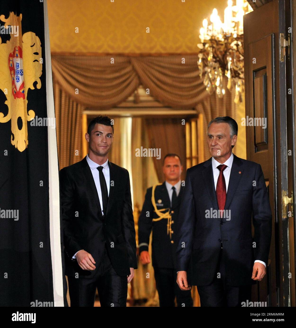 LISBON, Jan. 20, 2014 - Portuguese football super star Cristiano Ronaldo (L) walks into the awarding ceremony during which he is awarded the Grand Officer of the Order of Infante D. Henrique by Portuguese President Anibal Cavaco Silva at the Presidential Palace in Lisbon, Portugal, on Jan. 20, 2014. Ronaldo was awarded the country s top honor for his contribution to the national team and the prestige he has brought for Portugal around the world. (Xinhua/Zhang Liyun) (hy) (SP)PORTUGAL-LISBON-FOOTBALL-CRISTIANO RONALDO-TOP HONOR AWARDING PUBLICATIONxNOTxINxCHN   Lisbon Jan 20 2014 PORTUGUESE Foo Stock Photo