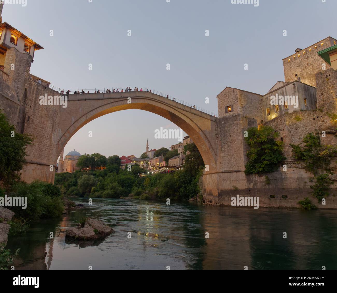 Visitors on Stari Most (Old Bridge) over the Neretva River on a summers evening. Mostar, Bosnia and Herzegovina, August 22, 2023. Stock Photo