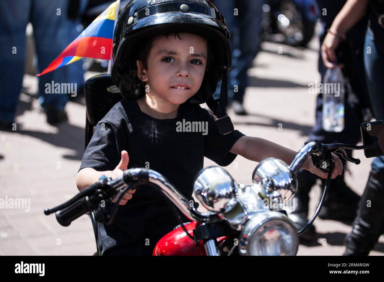 (140126) -- CARACAS, Jan. 26, 2014 (Xinhua) -- A Venezuelan boy participates in the annual mass for the blessing of the bikes 2014, at the Alfredo Sadel de las Mercedes Square, in Caracas, Venezuela, on Jan. 26, 2014. (Xinhua/Boris Vergara) (rt) (ah) VENEZUELA-CARACAS-SOCIETY-EVENT PUBLICATIONxNOTxINxCHN   Caracas Jan 26 2014 XINHUA a Venezuelan Boy participates in The Annual Mass for The Blessing of The Bikes 2014 AT The Alfredo  de Las Mercedes Square in Caracas Venezuela ON Jan 26 2014 XINHUA Boris Vergara RT AH Venezuela Caracas Society Event PUBLICATIONxNOTxINxCHN Stock Photo