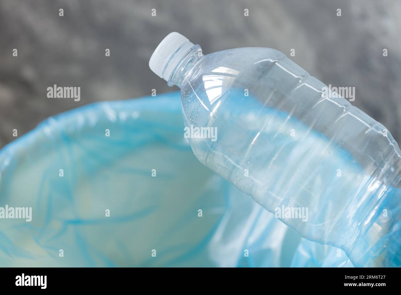 Sustainable Living - Plastic Bottle in Trash Can Stock Photo