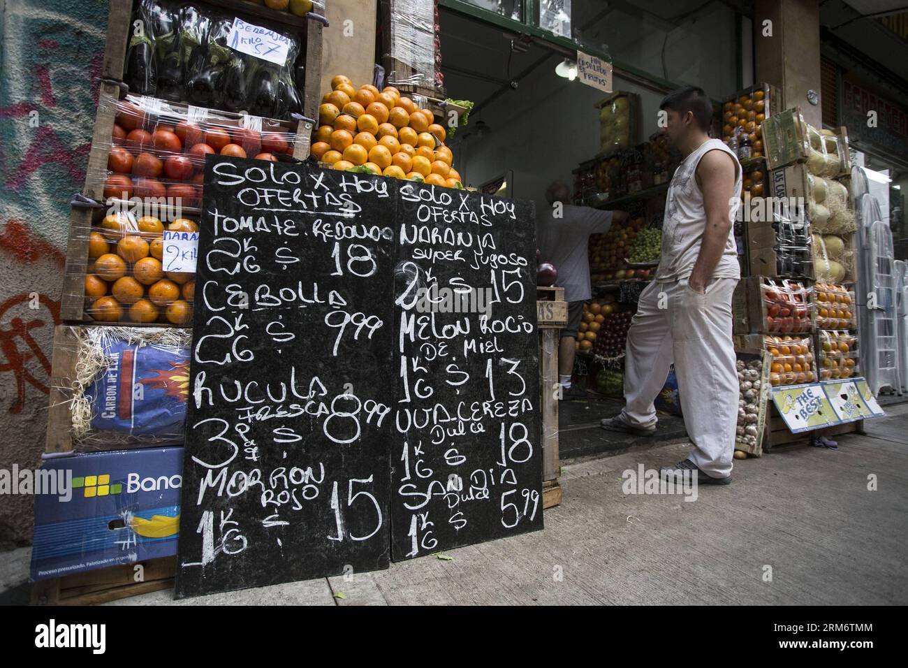 BUENOS AIRES, Jan. 29, 2014 - A man waits at a grocery store on the framework of the Cared Prices plan, implemented by the government to control inflation, in Buenos Aires City, capital of Argentina, on Jan. 29, 2014. Argentina s President Cristina Fernandez s goverment promoted a sharp devaluation of the Argentine peso. The Argentine peso fell 3.5 per cent against the U.S dollar at the official foreign exchange market, which represents the biggest devaluation of the local currency in a day since 2002, according to local press. (Xinhua/Martin Zabala) (ah) (ce) ARGENTINA-BUENOS AIRES-ECONOMY-DE Stock Photo