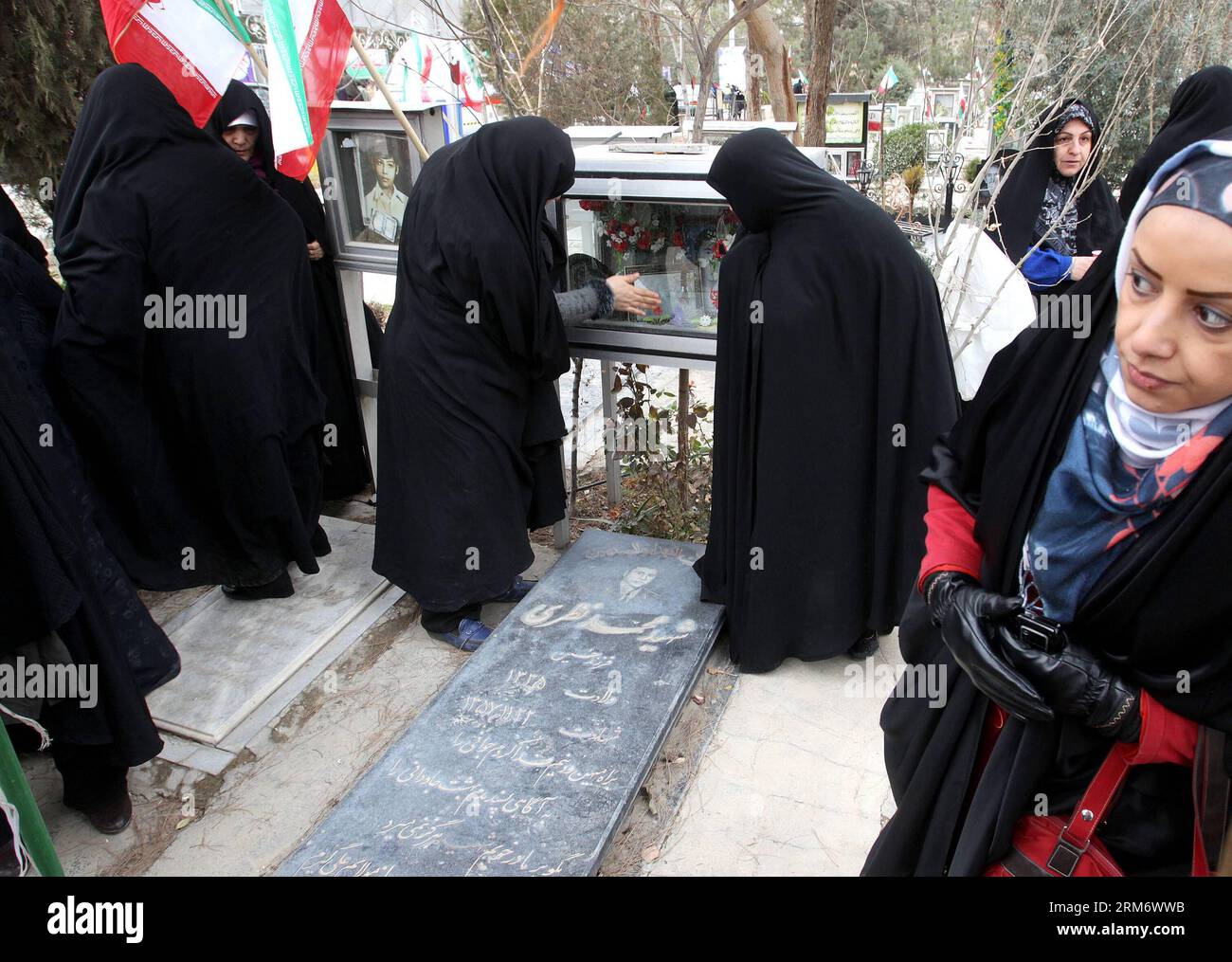 TEHRAN, (Xinhua) -- Iranian women visit the graves of people who were killed during the 1979 Islamic revolution at the Behesht-e Zahra cemetery outside Tehran, Iran, on Feb. 1, 2014, to mark the 35th anniversary of the Islamic revolution. (Xinhua/AhmadHalabisaz) IRAN-TEHRAN-ISLAMIC REVOLUTION-ANNIVERSARY-CEMETERY PUBLICATIONxNOTxINxCHN   TEHRAN XINHUA Iranian Women Visit The Graves of Celebrities Who Were KILLED during The 1979 Islamic Revolution AT The Behesht e Zahra Cemetery outside TEHRAN Iran ON Feb 1 2014 to Mark The 35th Anniversary of The Islamic Revolution XINHUA  Iran TEHRAN Islamic Stock Photo