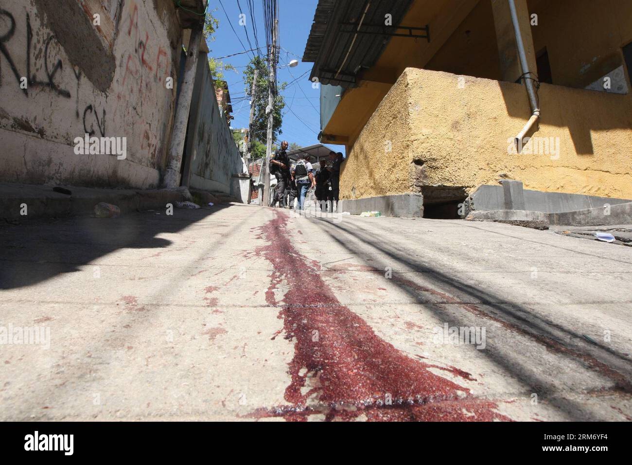 RIO DE JANEIRO, Feb. 4, 2014 - Police elements walk near the blood stain during a police operation, north of Rio de Janeiro, Brazil, on Feb. 4, 2014. According to the local press, the objective of this operation in which at least 10 persons died, was to arrest the traffickers of the command that participated in an attack on Sunday on the Peacemaker Police Unit. (Xinhua/Severino Silva/Agencia O Dia/Agencia Estado) BRAZIL OUT ATTENTION EDITORS EXPLICIT GRAPHIC CONTENT BRAZIL-RIO DE JANEIRO-SECURITY-OPERATION PUBLICATIONxNOTxINxCHN   Rio de Janeiro Feb 4 2014 Police Element Walk Near The Blood St Stock Photo