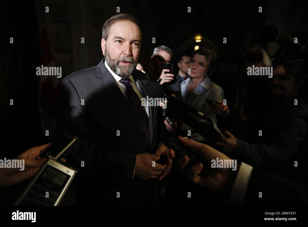 (140212) -- OTTAWA, (Xinhua) -- Thomas Mulcair, leader of the opposition New Democratic Party, speaks to reporters about the new federal budget, unveiled by Finance Minister Jim Flaherty at Parliament Hill in Ottawa, Canada, Feb. 11, 2014. Jim Flaherty on Tuesday unveiled a federal budget projecting a surplus in 2015. (Xinhua/David Kawai) CANADA-OTTAWA-BUDGET PUBLICATIONxNOTxINxCHN   Ottawa XINHUA Thomas  Leader of The Opposition New Democratic Party Speaks to Reporters About The New Federal Budget unveiled by Finance Ministers Jim Flaherty AT Parliament Hill in Ottawa Canada Feb 11 2014 Jim F Stock Photo