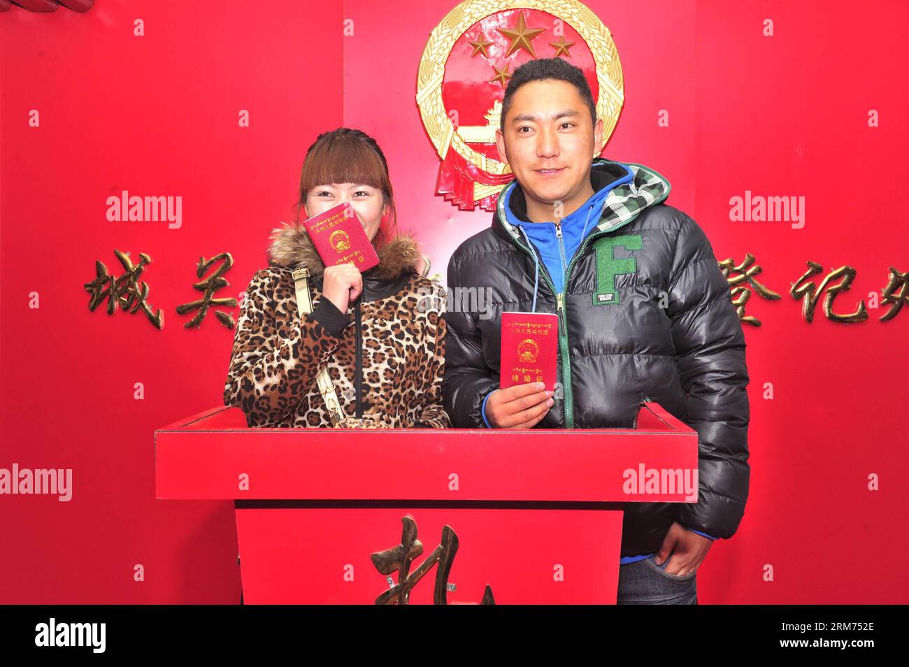 (140214) -- LHASA, Feb. 14, 2014 (Xinhua) -- Newlyweds holding their marriage certificates pose for photos at a marriage registry on the Valentine s Day as well as the Chinese traditional Lantern Festival in Lhasa, capital of southwest China s Tibet Autonomous Region, Feb. 14, 2014. Many newlyweds chose to get marriage licenses on the Valentine s Day this year, as it coincides with the Lantern Festival, the 15th day of the first month of the Chinese lunar calendar. (Xinhua/Liu Kun) (lfj) CHINA-VALENTINE S DAY-MARRIAGE REGISTRATION (CN) PUBLICATIONxNOTxINxCHN   Lhasa Feb 14 2014 XINHUA Newlywed Stock Photo