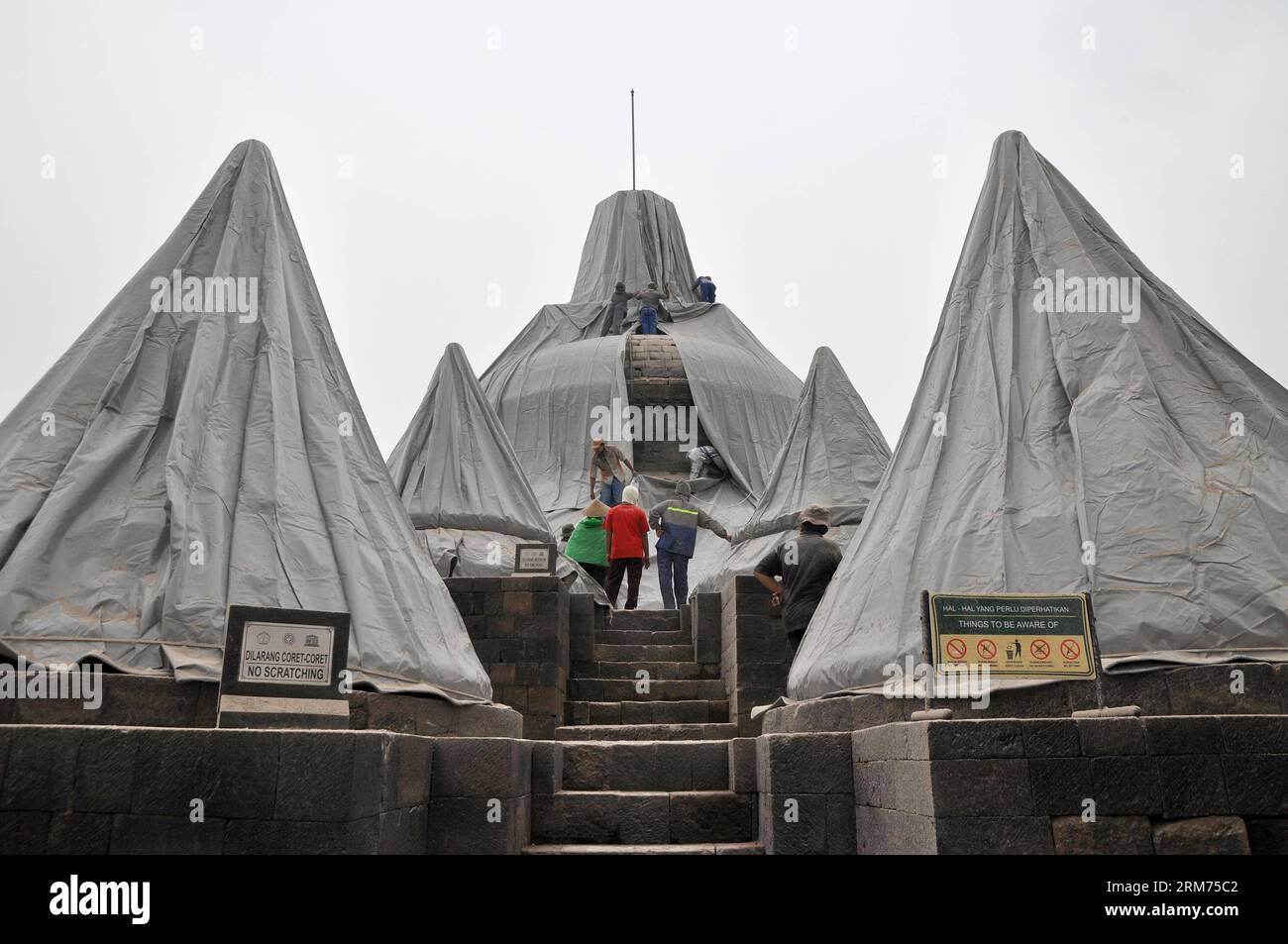 (140214) -- MAGELANG, Feb. 14, 2014 (Xinhua) -- Workers close some stupas of the Borobudur Temple to avoid volcanic ash from Mount Kelud, in Magelang, Central Java province of Indonesia, Feb. 14, 2014. Mount Kelud volcano eruption in East Java, Indonesia, killed two people and displaced more than 100,000 others, an official said on Friday. (Xinhua/Alif)(hy) INDONESIA-MAGELANG-BOROBUDUR TEMPLE-VOLCANO PUBLICATIONxNOTxINxCHN   Magelang Feb 14 2014 XINHUA Workers Close Some Stupas of The Borobudur Temple to avoid Volcanic Ash from Mount Kelud in Magelang Central Java Province of Indonesia Feb 14 Stock Photo