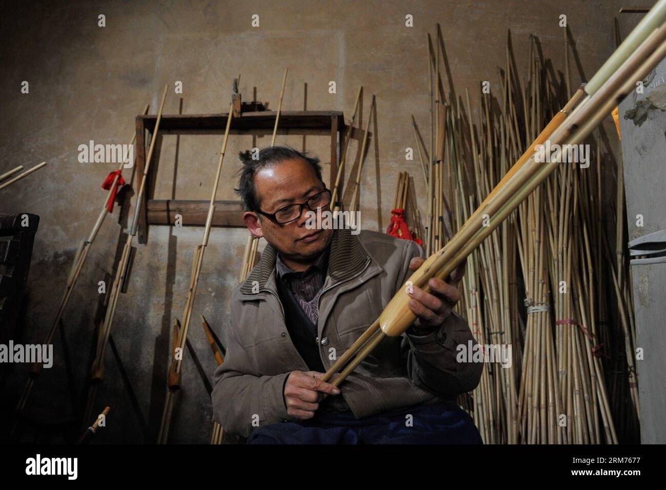 (140215) -- KAILI, Feb. 15, 2014 (Xinhua) -- Craftsman Pan Rouda makes Lusheng, a kind of reed-pipe wind instrument, in Xin guang Village, Zhouxi Township, Qiandongnan Miao and Dong Autonomous Prefecture of southwest China s Guizhou Province, Feb. 15, 2014. Dubbed as the home of Lusheng , Xin guang has the tradition of making the wind instrument for some 400 years with 65 family workshops still making it at present. In the year of 2006, China listed the craft as the national intangible cultural heritage. (Xinhua/Ou Dongqu) (hdt) CHINA-GUIZHOU-LUSHENG (CN) PUBLICATIONxNOTxINxCHN   Kaili Feb 15 Stock Photo
