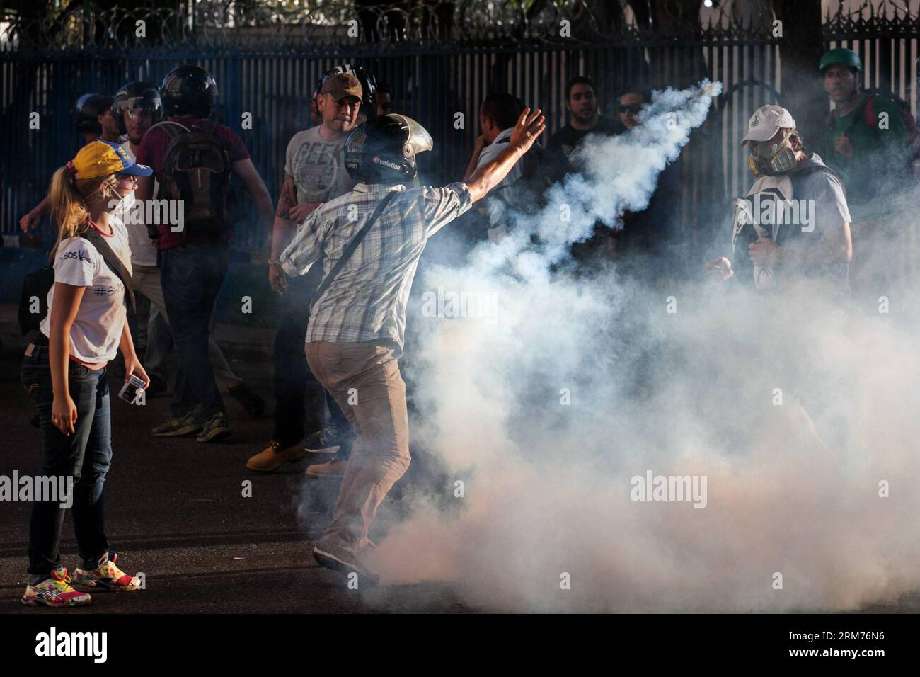 Students and riot police clash during a protest by government opponents, in the city of Caracas, capital of Venezuela, on Feb. 15, 2014. (Xinhua/Boris Vergara) (bxq) VENEZUELA-CARACAS-SOCIETY-PROTEST PUBLICATIONxNOTxINxCHN   Students and Riot Police Clash during a Protest by Government opponents in The City of Caracas Capital of Venezuela ON Feb 15 2014 XINHUA Boris Vergara  Venezuela Caracas Society Protest PUBLICATIONxNOTxINxCHN Stock Photo