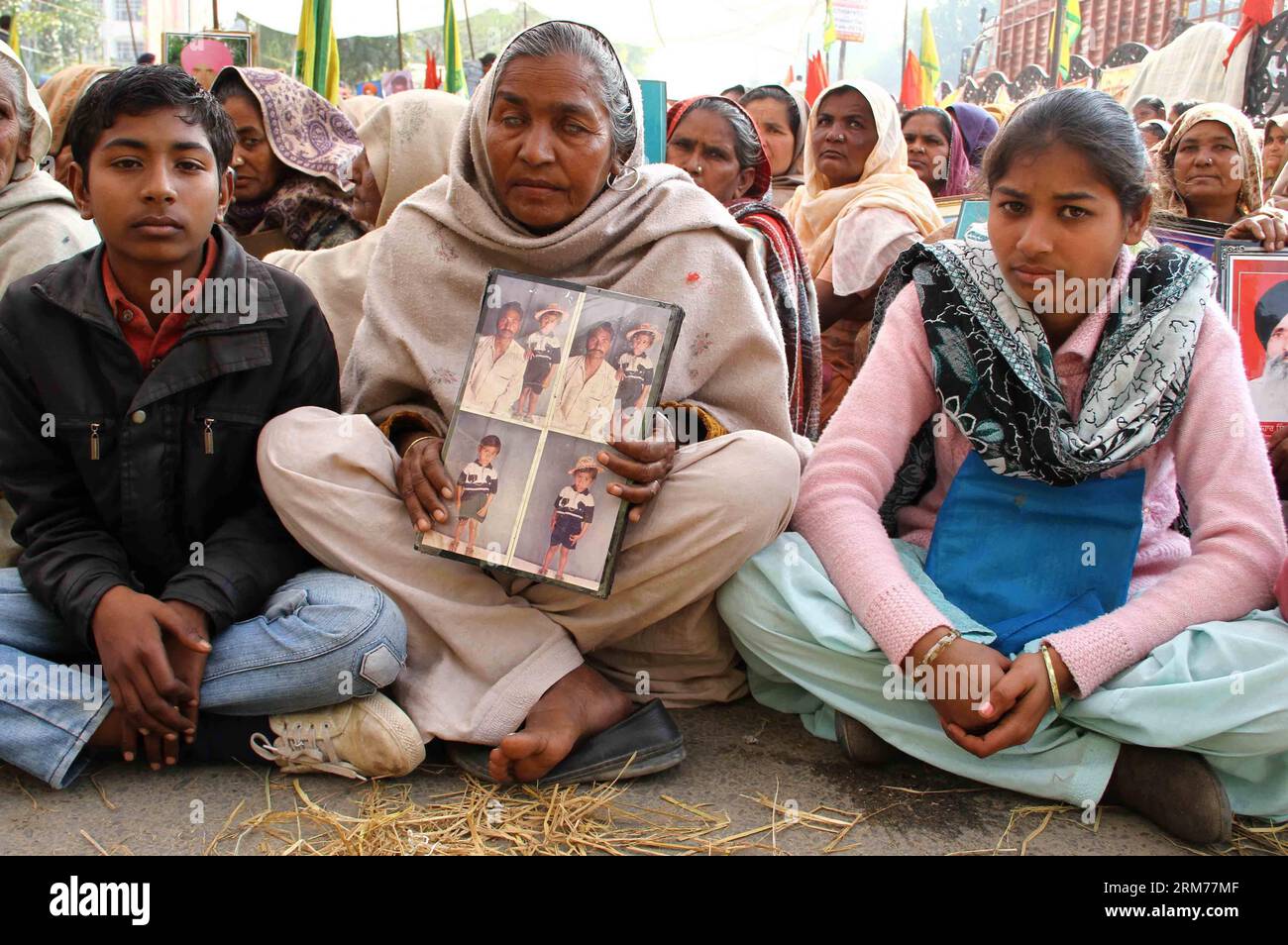 (140217) -- PUNJAB, Feb. 17, 2014 (Xinhua) -- Farmers hold photographs of their relatives who committed suicide, during a protest opposite mini secretariat building in Bathinda, India, Feb. 17, 2014. The protesters demand for compensation to farmers and farm laborers who had committed suicide due to debt. They also want the state government to write off the farmers debts and allot plots to homeless farm laborers. (Xinhua/Stringer) INDIA-PUNJAB-FARMER PROTEST PUBLICATIONxNOTxINxCHN   Punjab Feb 17 2014 XINHUA Farmers Hold Photographs of their Relatives Who Committed Suicide during a Protest opp Stock Photo