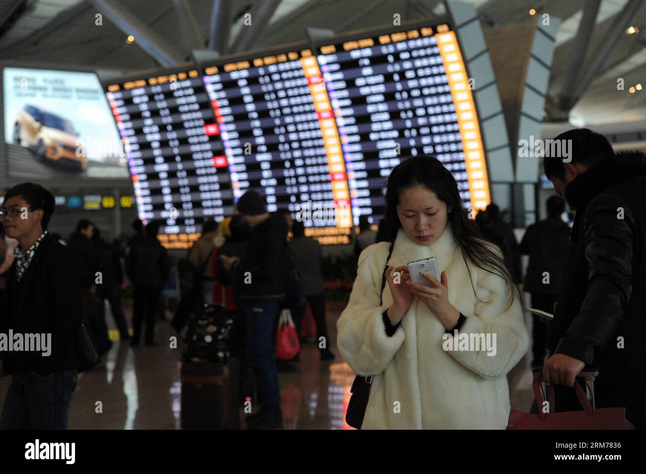 (140218) -- GUIYANG, Feb. 18, 2014 (Xinhua) -- Stranded passengers check on their flights information at Longdongbao International Airport in Guiyang, capital of southwest China s Guizhou Province, Feb. 18, 2013. Heavy snow led to temporary closure of the airport at 8 a.m. Tuesday for snow and ice removal. More than 90 flights were canceled and over 4,800 passengers were affected before the airport was reopened at noon. (Xinhua/Tao Liang)(wjq) CHINA-GUIZHOU-SNOW-AIRPORT CLOSURE (CN) PUBLICATIONxNOTxINxCHN   Guiyang Feb 18 2014 XINHUA stranded Passengers Check ON their Flights Information AT Lo Stock Photo