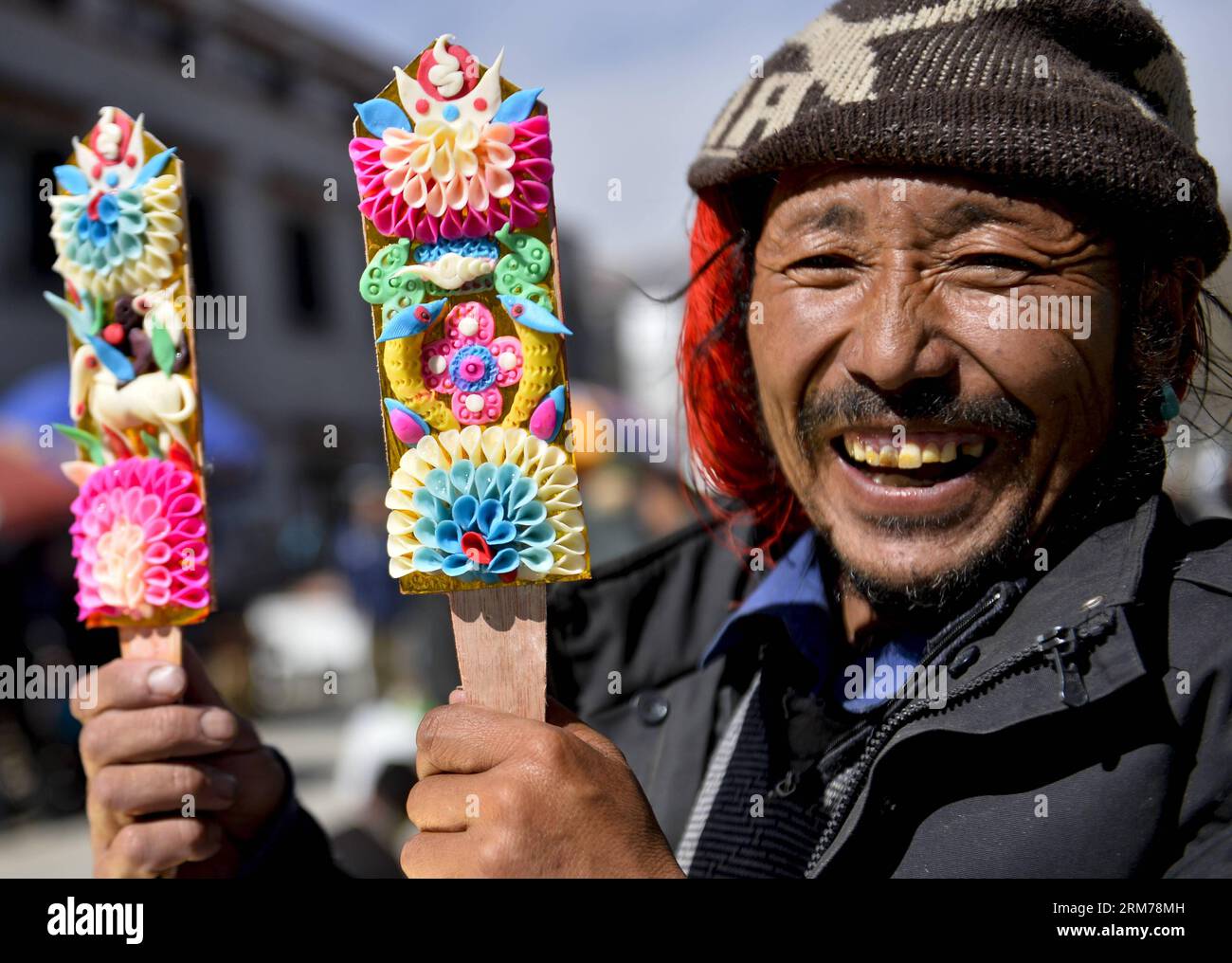(140219) -- LHASA, Feb. 19, 2014 (Xinhua) -- Zhaxi Logyai from Nyemo County sells butter sculptures before the coming Tibetan losar or the Tibetan New Year at a bazaar in Lhasa, capital of southwest China s Tibet Autonomous Region, Feb. 19, 2014. People of the Tibetan ethnic group will embrace the Wood Horse Losar on March 2. (Xinhua/Purbu Zhaxi) (lfj) CHINA-LHASA-LOSAR-BAZAAR (CN) PUBLICATIONxNOTxINxCHN   Lhasa Feb 19 2014 XINHUA Zhaxi Logyai from  County sells Butter Sculptures Before The Coming Tibetan Losar or The Tibetan New Year AT a Bazaar in Lhasa Capital of Southwest China S Tibet Aut Stock Photo