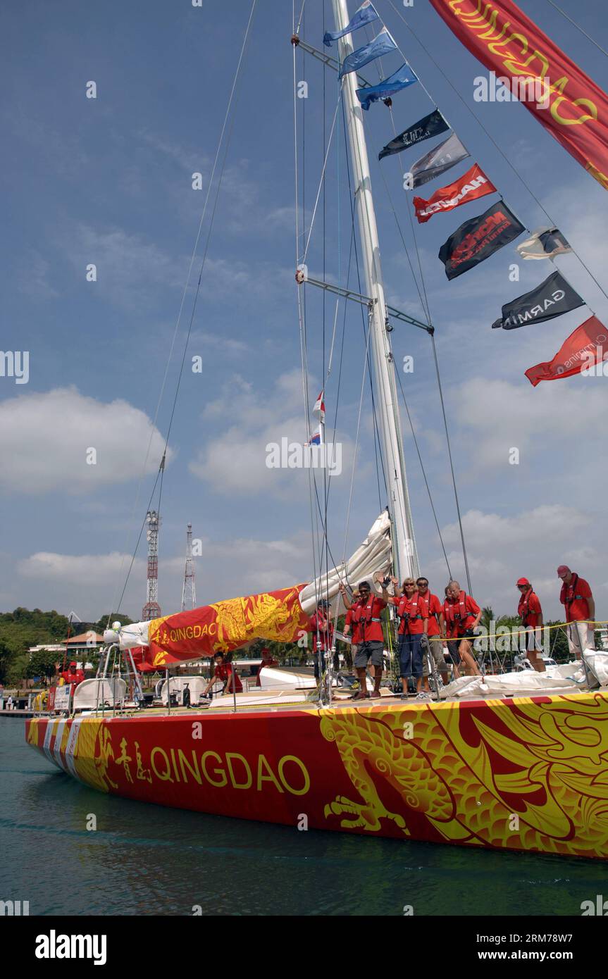 (140219) -- SINGAPORE, Feb. 19, 2014 (Xinhua) -- The crew members of Yacht Qingdao wave goodbye as the yacht sails from a bay in Sentosa, Singapore, Feb. 19, 2014. The 12-strong fleet of the Clipper Race departed Sentosa Wednesday on a 2,500 nautical mile leg of the race to the Chinese city of Qingdao. With a route of 40,000 nautical miles, Clipper Round the World Race is known as one of the longest round-the-globe yacht races in the world. It is also known as the only round-the-world ocean race that welcomes novices from all over the world and turn them into ocean racers. (Xinhua/Chen Jipeng) Stock Photo