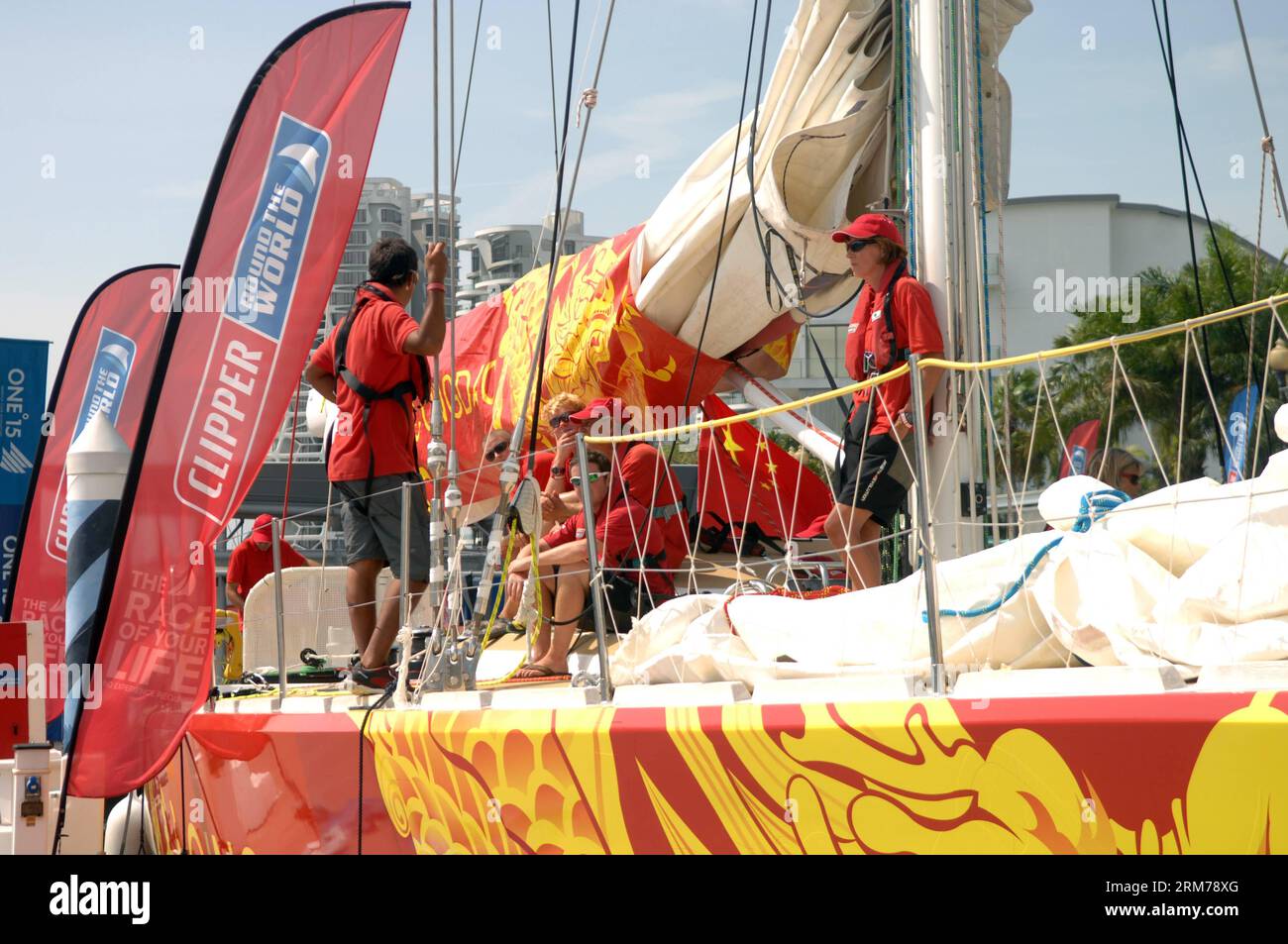 (140219) -- SINGAPORE, Feb. 19, 2014 (Xinhua) -- The crew members of Yacht Qingdao get ready before sailing from Singapore to Qingdao in Sentosa, Singapore, Feb. 19, 2014. The 12-strong fleet of the Clipper Race departed Sentosa Wednesday on a 2,500 nautical mile leg of the race to the Chinese city of Qingdao. With a route of 40,000 nautical miles, Clipper Round the World Race is known as one of the longest round-the-globe yacht races in the world. It is also known as the only round-the-world ocean race that welcomes novices from all over the world and turn them into ocean racers. (Xinhua/Chen Stock Photo