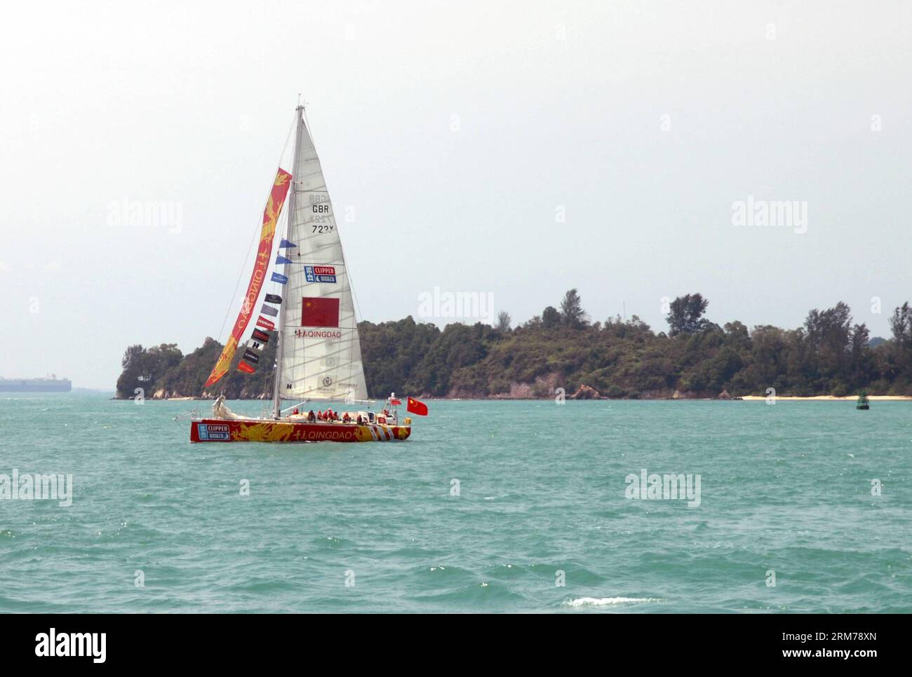 (140219) -- SINGAPORE, Feb. 19, 2014 (Xinhua) -- The Yacht Qingda sails off Sentosa island in Singapore to Qingdao, China, Feb. 19, 2014. The 12-strong fleet of the Clipper Race departed Sentosa Wednesday on a 2,500 nautical mile leg of the race to the Chinese city of Qingdao. With a route of 40,000 nautical miles, Clipper Round the World Race is known as one of the longest round-the-globe yacht races in the world. It is also known as the only round-the-world ocean race that welcomes novices from all over the world and turn them into ocean racers. (Xinhua/Chen Jipeng) (SP)SINGAPORE-CHINA-QINGD Stock Photo