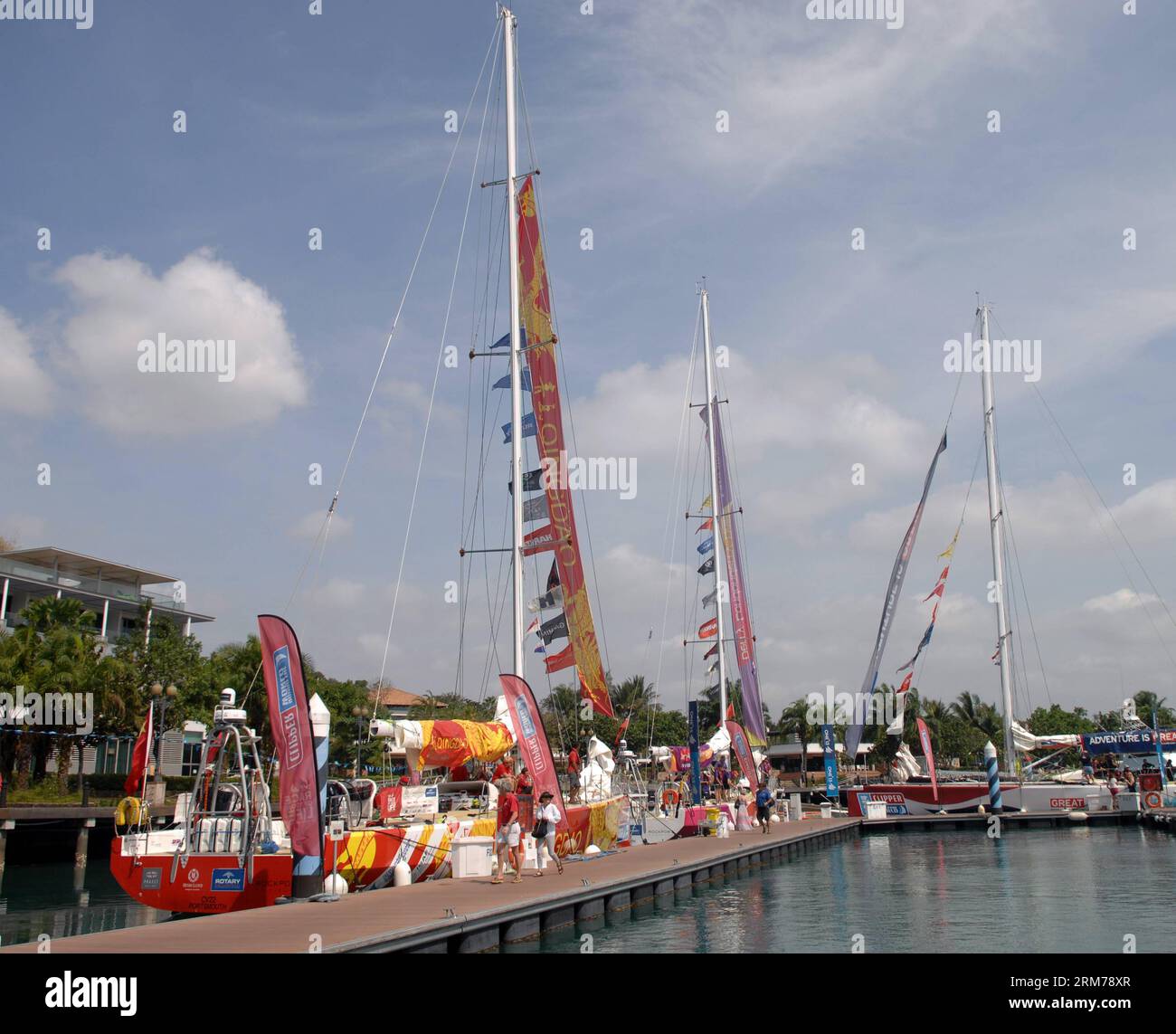 (140219) -- SINGAPORE, Feb. 19, 2014 (Xinhua) -- The Yacht Qingdao (1st L) gets ready to sail from Singapore to its home port of Qingdao in Sentosa, Singapore, Feb. 19, 2014. The 12-strong fleet of the Clipper Race departed Sentosa Wednesday on a 2,500 nautical mile leg of the race to the Chinese city of Qingdao. With a route of 40,000 nautical miles, Clipper Round the World Race is known as one of the longest round-the-globe yacht races in the world. It is also known as the only round-the-world ocean race that welcomes novices from all over the world and turn them into ocean racers. (Xinhua/C Stock Photo