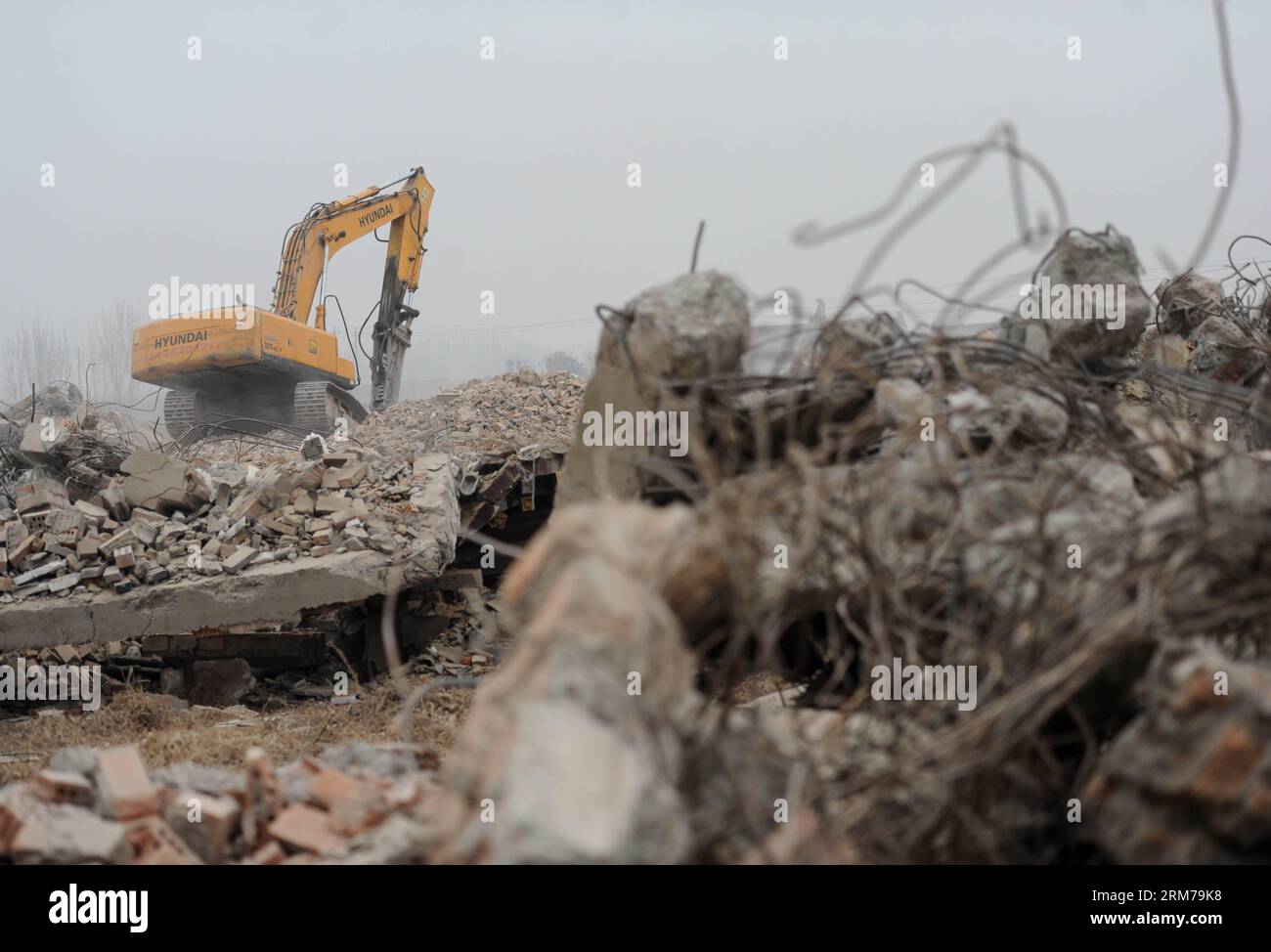 (140220) -- BEIJING, Feb. 20, 2014 (Xinhua) -- An excavator works on ruins of illegal houses demolished in Zhenggezhuang Village, Beiqijia Township of Changping District on the outskirt of Beijing, China, Feb. 20, 2014. Those illegal houses cover an area of 108.55 mu (about 7.24 hectares) , which will be used for tree planting after complete of demolition. (Xinhua/Luo Xiaoguang) (hdt) CHINA-BEIJING-CHANGPING-ILLEGAL HOUSES-DEMOLITION (CN) PUBLICATIONxNOTxINxCHN   Beijing Feb 20 2014 XINHUA to excavator Works ON Ruins of illegal Houses Demolished in  Village  Township of Chang Ping District ON Stock Photo