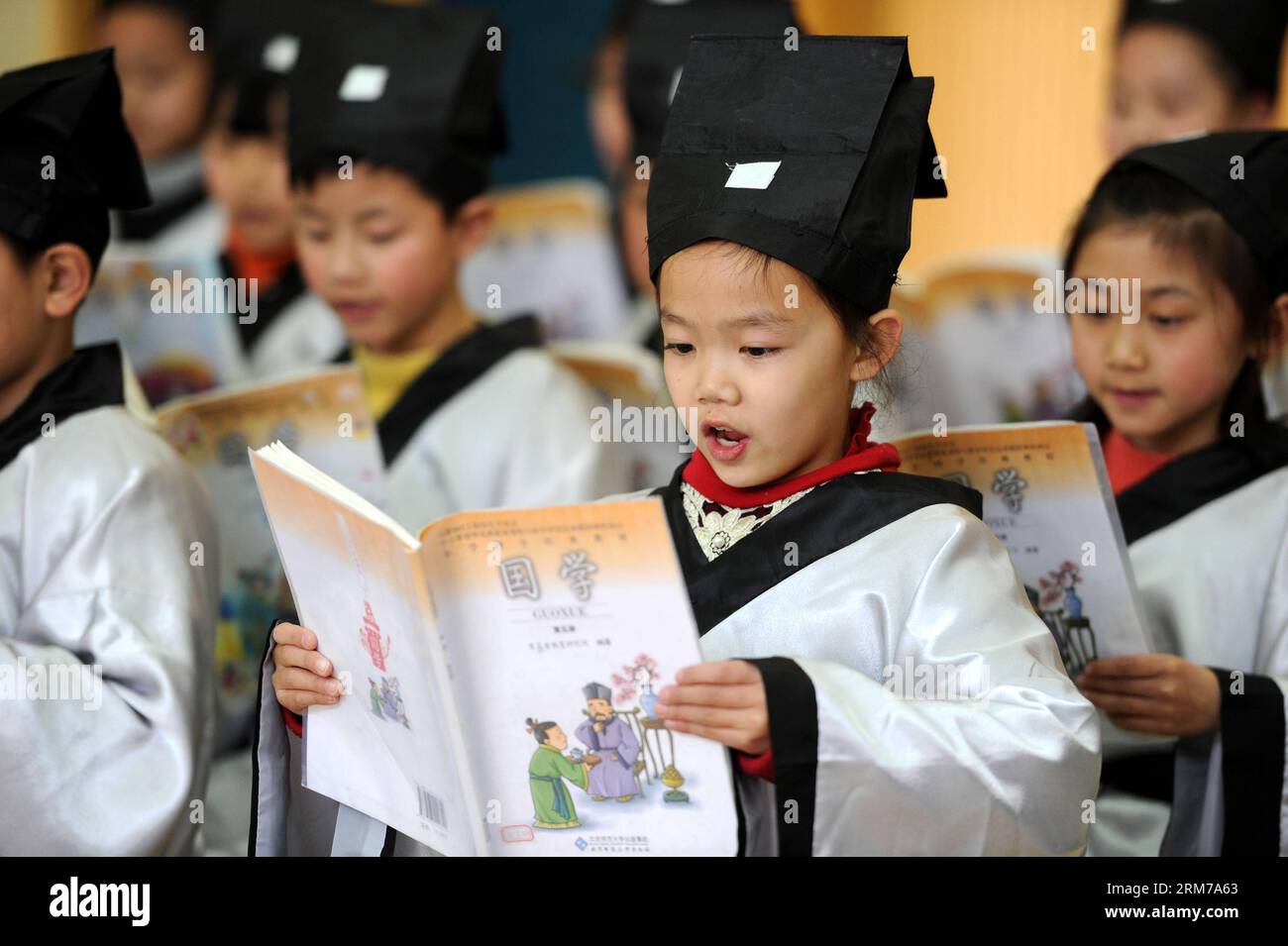 140221 -- HEFEI, Feb. 21, 2014 Xinhua -- Students read Lun Yu , or the Analects of Confucius, at Xiyou Primary School in Hefei, capital of east China s Anhui Province, Feb. 21, 2014. Friday marks the International Mother Language Day, which has been observed every year on February 21 since 2000 to promote linguistic and cultural diversity and multilingualism. Xinhua/Liu Junxiwjq CHINA-HEFEI-INT L MOTHER LANGUAGE DAY CN PUBLICATIONxNOTxINxCHN Stock Photo
