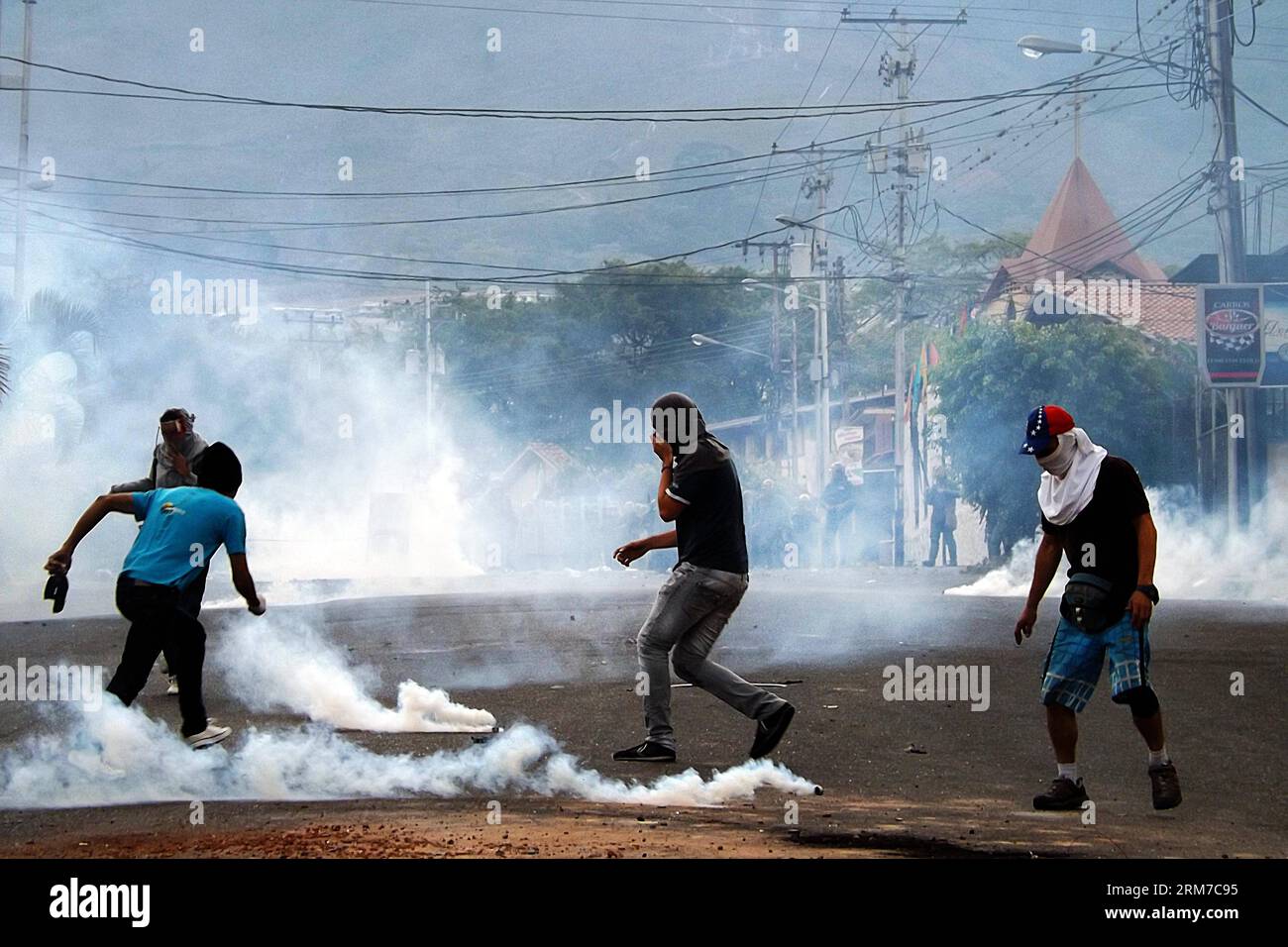 TACHIRA, Feb. 24, 2014 - Students clash with members of the National Bolivarian Guard during a protest in San Cristobal, Tachira state, Venezuela, on Feb. 24, 2014. (Xinhua/George Castro) (fnc) (sp) VENEZUELA-TACHIRA-SOCIETY-PROTEST PUBLICATIONxNOTxINxCHN   Tachira Feb 24 2014 Students Clash With Members of The National Bolivarian Guard during a Protest in San Cristobal Tachira State Venezuela ON Feb 24 2014 XINHUA George Castro FNC SP Venezuela Tachira Society Protest PUBLICATIONxNOTxINxCHN Stock Photo