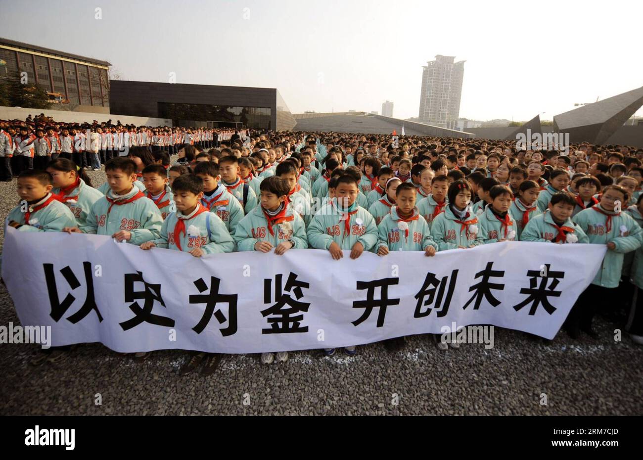 (140225) -- BEIJING, Feb. 25, 2014 (Xinhua) -- Delegates of primary school students hold a banner reading drawing lessons from the history and creating the future during a rally to mourn the victims of the Nanjing Massacre, at the square in front of the memorial hall of the Chinese victims massacred by Japanese soldiers in Nanjing, capital of east China s Jiangsu Province, Dec. 13, 2008. Chinese lawmakers are mulling making December 13 a national memorial day to commemorate those killed by Japanese aggressors during the Nanjing Massacre. The draft decision will be discussed at the bi-monthly s Stock Photo