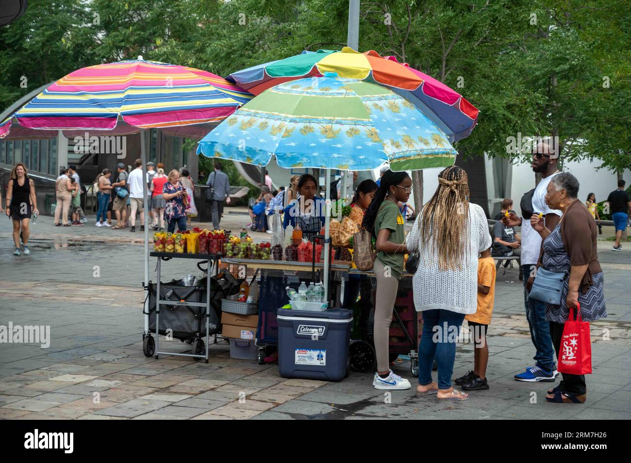Fresh fruit vendor and customers outdoors in Manhattan New York City