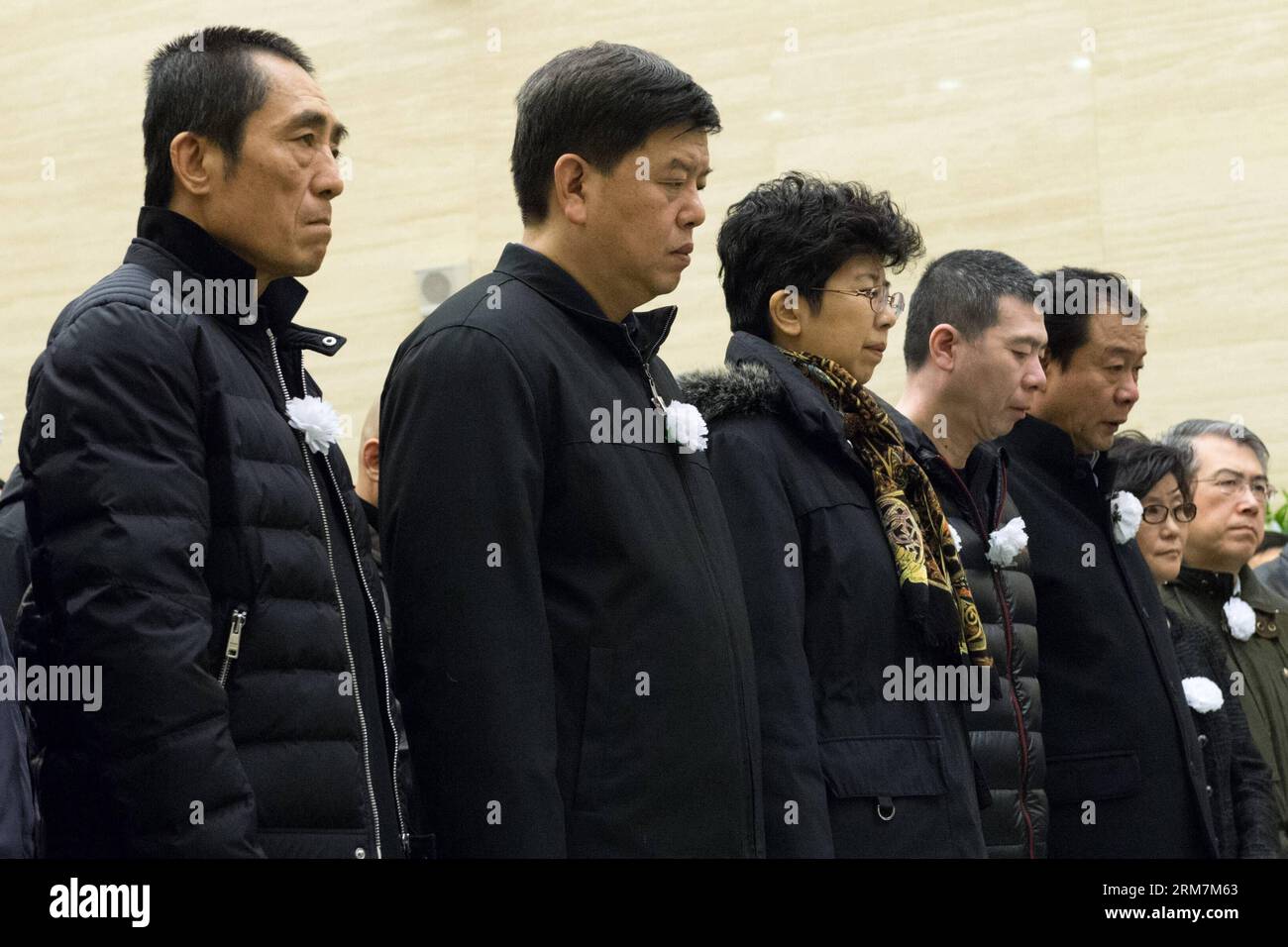 Film directors Zhang Yimou (1st L) and Feng Xiaogang (4th L) mourn for the late film director Wu Tianming at a memorial service held at the Babaoshan Funeral Home in Beijing, capital of China, March 8, 2014. Wu Tianming, who died of a heart attack on March 4 at the age of 75, was a leading figure of China s Fourth Generation film directors. While he was head of the renowned Xi an Film Studio, Wu spotted talents such as Zhang Yimou and Gu Changwei who later became representatives of China s Fifth Generation film directors. His major works include Old Well and Life . (Xinhua/Wu Kaixiang) (lmm) C Stock Photo